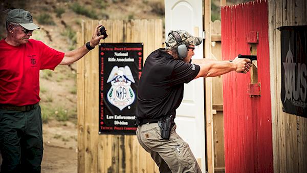 NRA Law Enforcement Competition shooting through an open door.